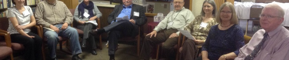 A group of older adults sitting in a circle in a cozy room.