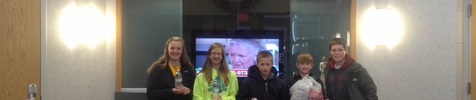 Group of five people posing inside Iowa City Cancer Treatment Center.