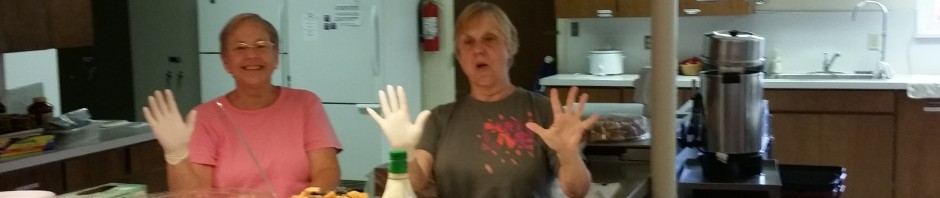 Two women preparing food together in a kitchen.