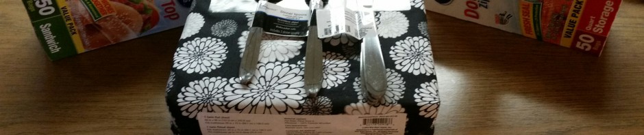 A creative table setting using stacked toilet paper rolls with cutlery and glasses.