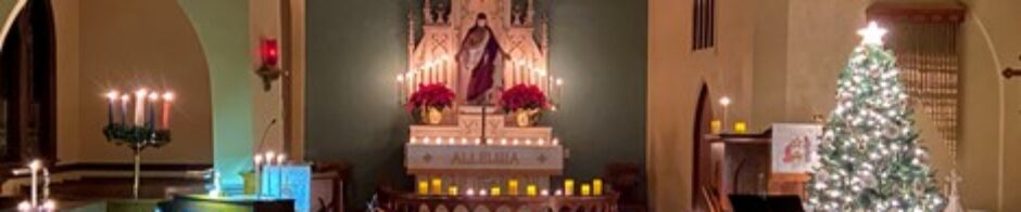 A religious altar adorned with candles, flowers, and a statue of Jesus Christ.