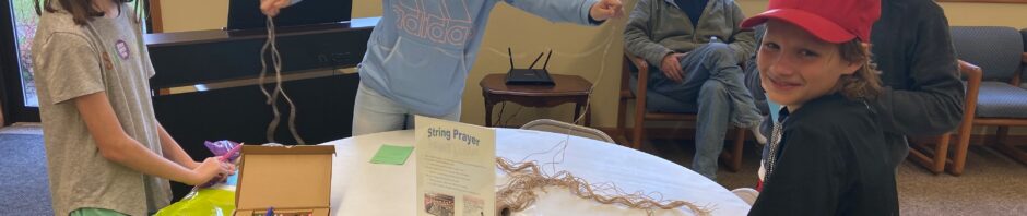 A group of people enjoying a cheerful activity around a table with crafts and games.