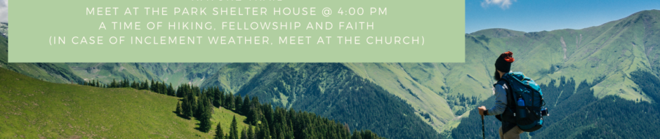 Hiking in a scenic mountain landscape under a clear blue sky.