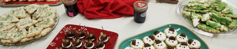 A festive holiday table with cookies and a Santa centerpiece.