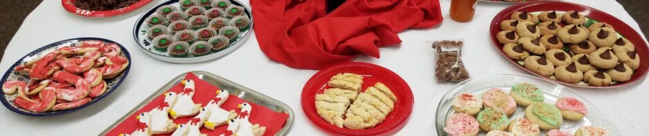 A table with assorted cookies and desserts arranged on plates.