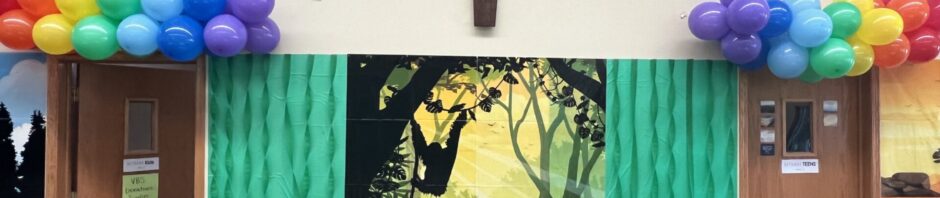 Church altar decorated with balloons and a cross above.