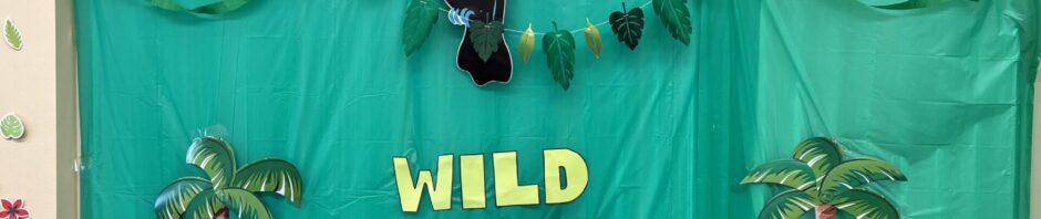 A green backdrop with tropical decorations and the words 'WILD LIFE'.