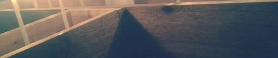 Candles lit for a prayer event around a cross.