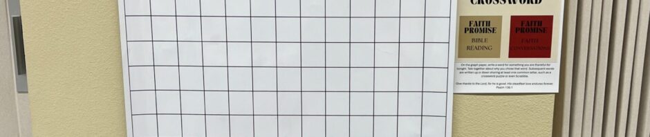Blank crossword puzzle board mounted on wall for faith-based event.