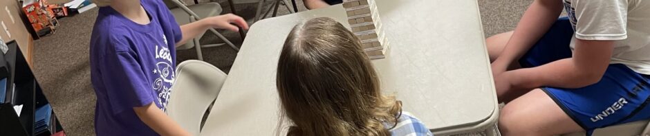 Four people engaged in a lively conversation around a table in a casual setting.