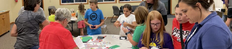 A group of people engaged in arts and crafts at a table.