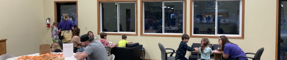 People engaging in group activities in a community room.